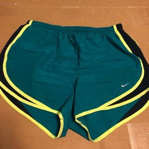 Teal Dri-Fit Nike shorts with neon yellow seams
